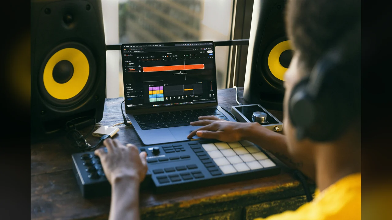 SongCoverGen: a producer in headphones rebuilding a song arrangement on a laptop and pad controller